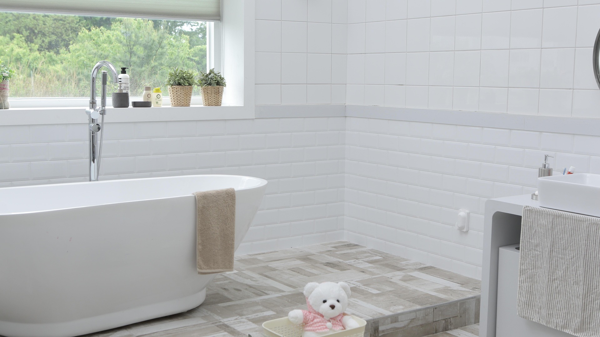Sparkling clean marble bathroom with bathtub and glass shower